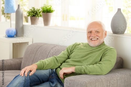 Portrait of happy senior on sofa