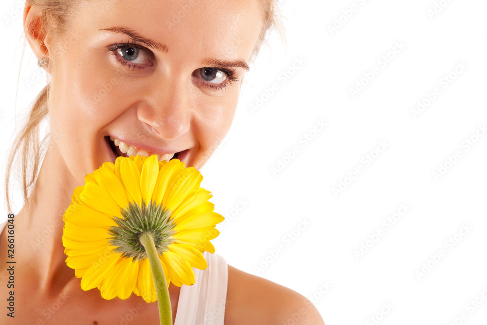 woman smelling a yellow flower