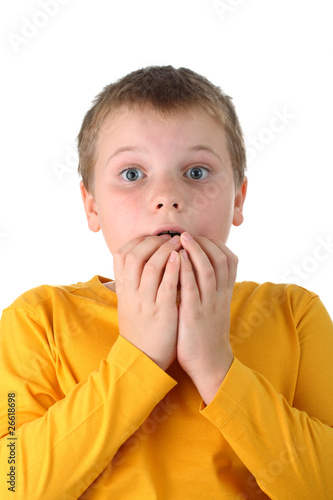 Bilde på lerret Worried boy with his fingers in mouth isolated on white