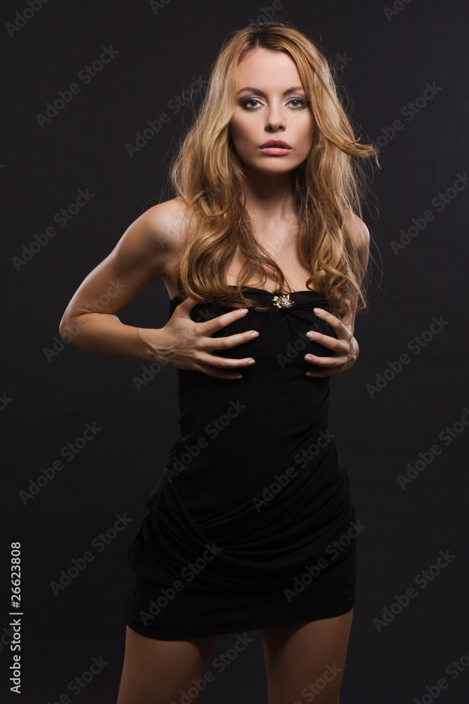 Fototapeta premium sexy woman touch her breast in a dark studio