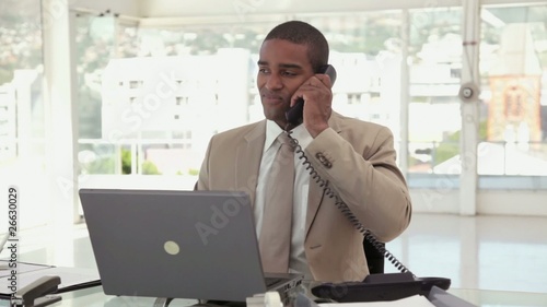 Businessman Using a Phone at the Office