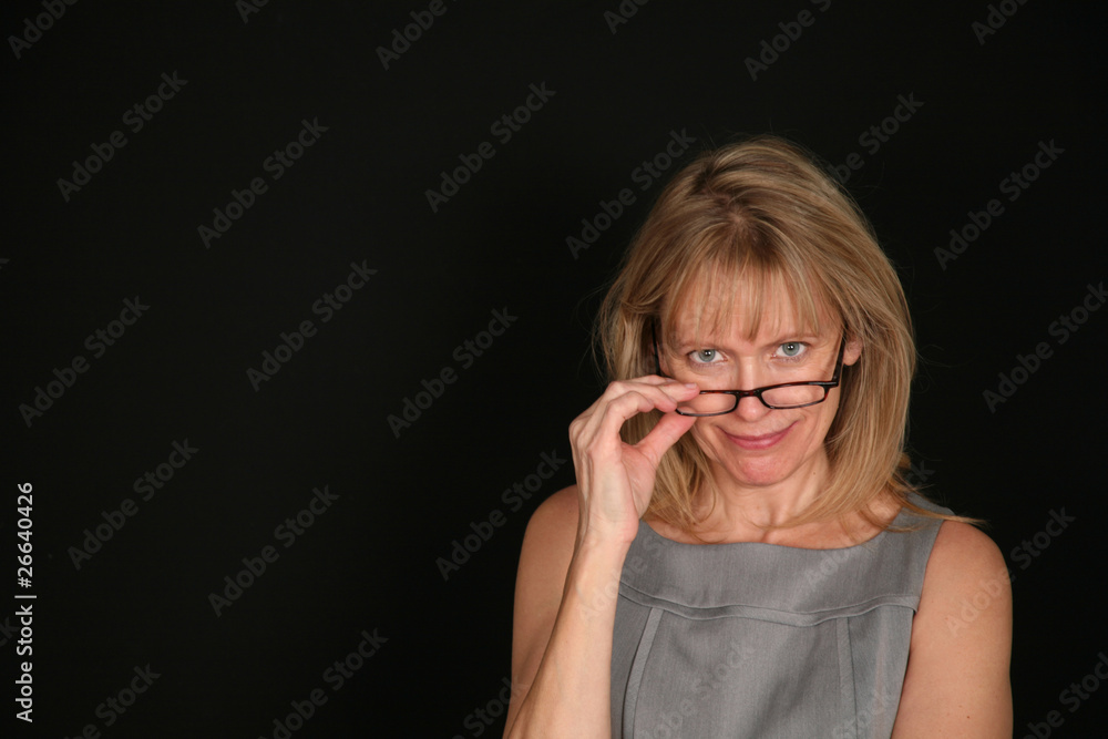 smiling woman looking over glasses smiling woman looking over glasses
