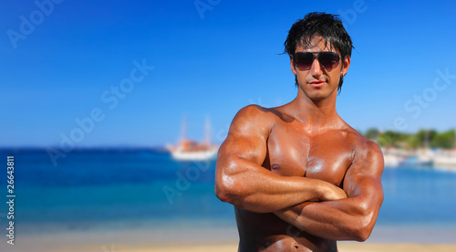 fit man posing in a beach