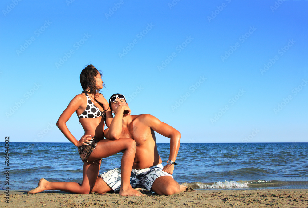 An attractive couple relaxing at the beach An attractive couple relaxing at the beach