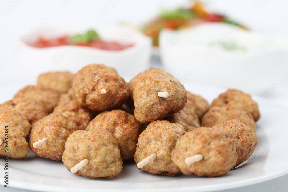 Roast meatballs with tzatziki and tomato dip and salad Roast meatballs with tzatziki and tomato dip and salad