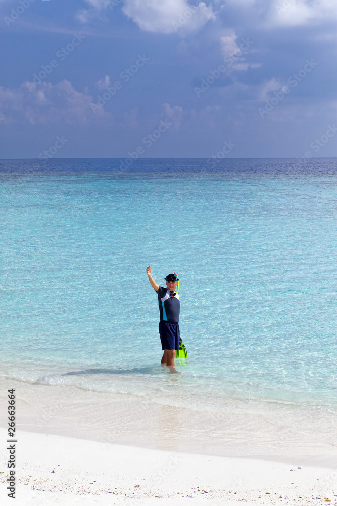 Young sports man with flippers, mask and tube at ocean. Young sports man with flippers, mask and tube at ocean.