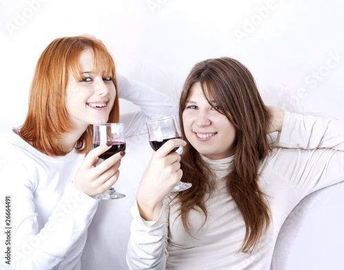 Two girlfriends with two glasses of wine.