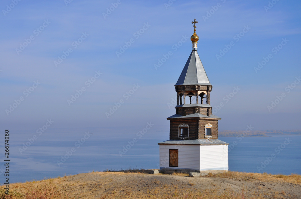 Russian wooden church on river coast