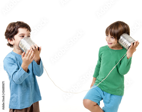 Two boys talking on a tin can phone