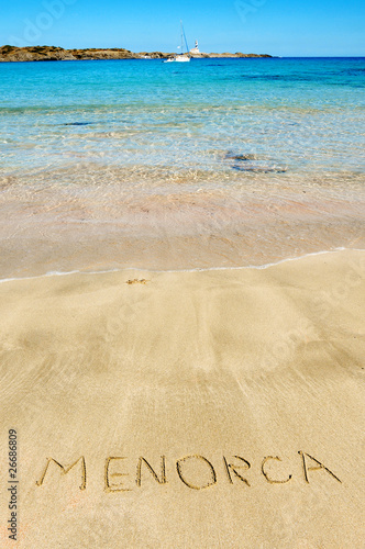 Menorca written in the sand of a beach
