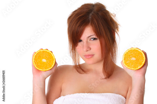 smiling young haelthy woman holding the orange in her hand