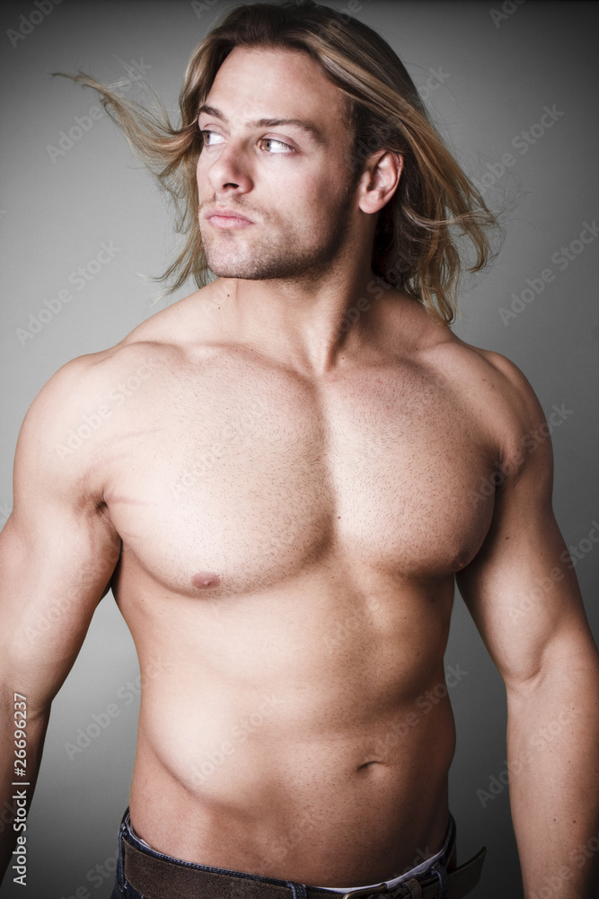 Muscular man measuring his waist Muscular man measuring his waist