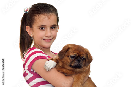 Beautiful girl holding a small pekingese dog on a white backgrou photo