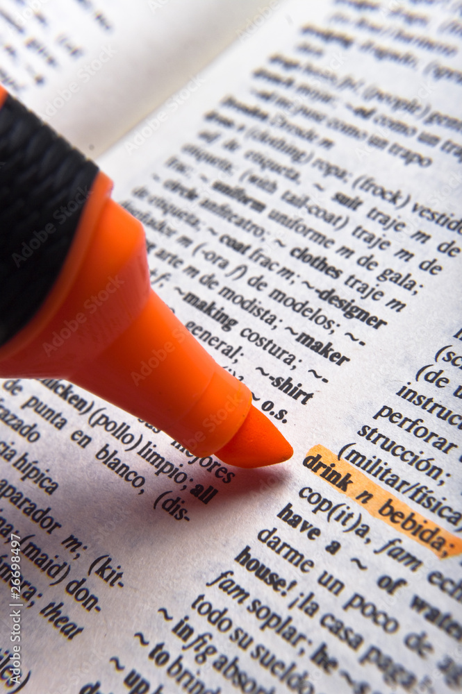 Orange marker and word drink in Spanish dictionary Stock Photo | Adobe Stock