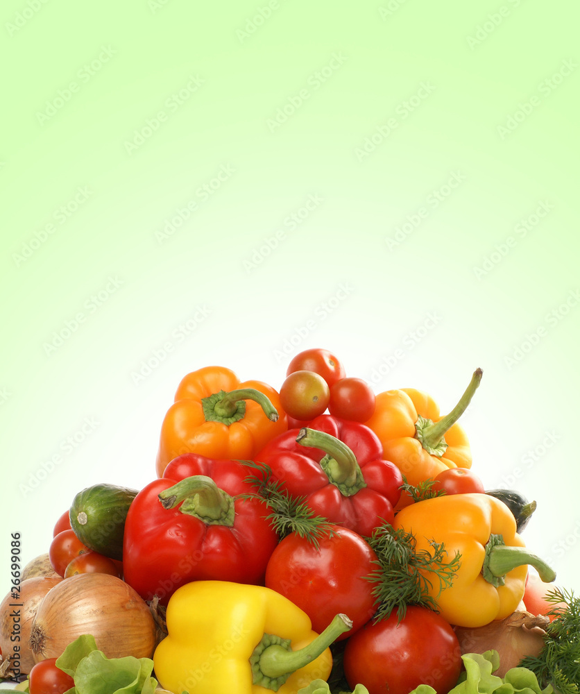 A pile of fresh and tasty vegetables on a green background A pile of fresh and tasty vegetables on a green background