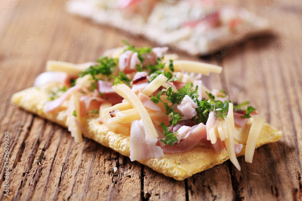 Crackers with ham and cheese topping