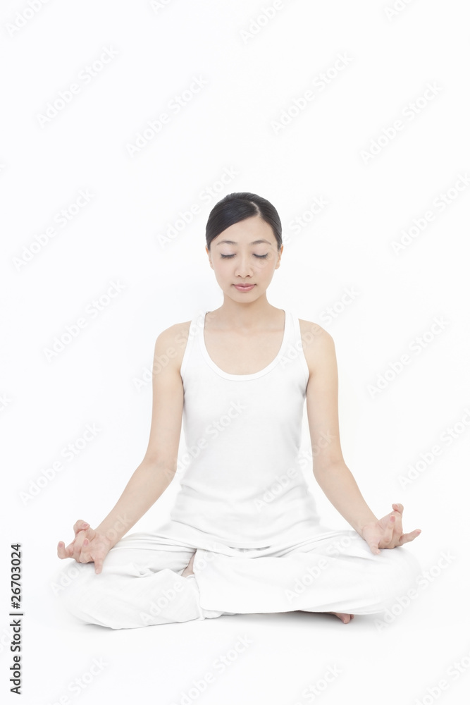 Asian model doing yoga on white background Asian model doing yoga on white background