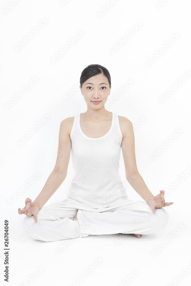 Asian model doing yoga on white background Asian model doing yoga on white background