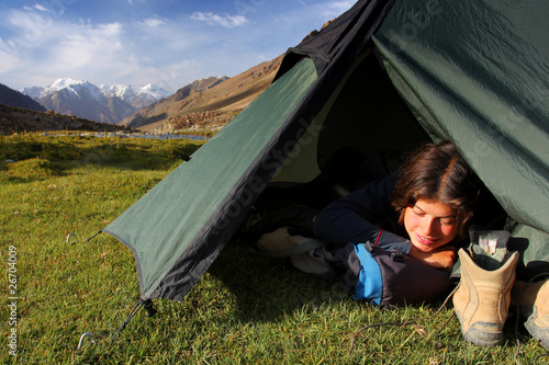 Young woman sleeping in tent in the mountains