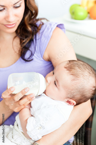 Portrait of a mother feeding her newborn child