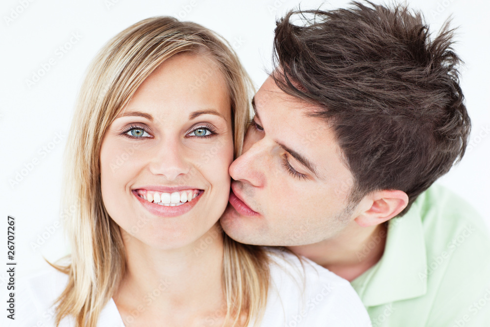 Portrait of a cute man kissing his girlfriend Portrait of a cute man kissing his girlfriend