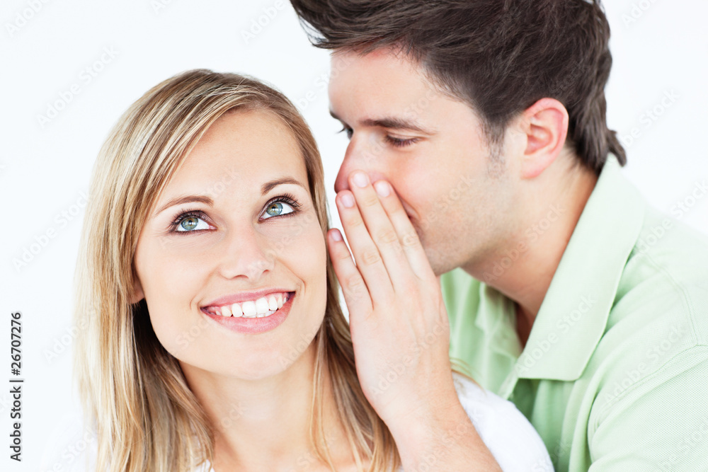 Young man whispering something to his attentive friend Young man whispering something to his attentive friend