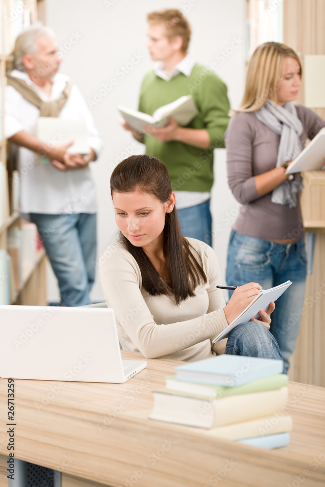 High school library - Student with note pad High school library - Student with note pad