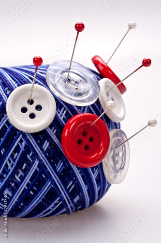pins in wool ball with buttons