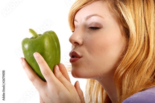 young beauty kisses a green paprika (white background)