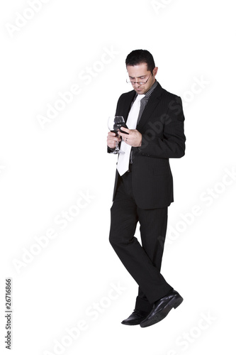 Businessman  with a glass of drink texting photo