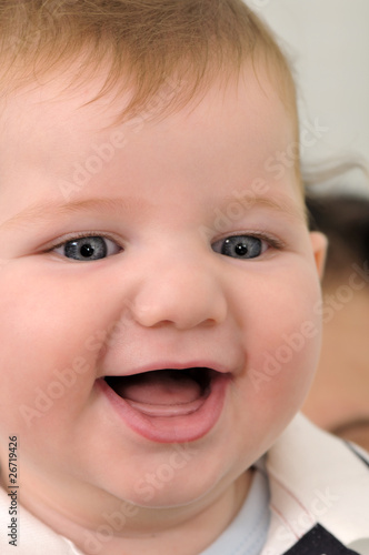 Laughing ittle baby boy close up.