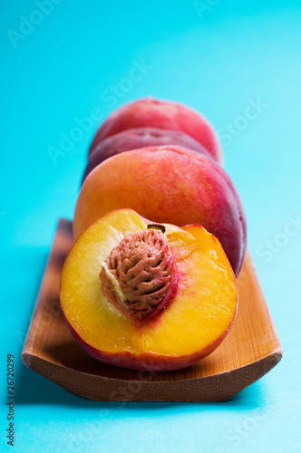 Ripe peach on blue background