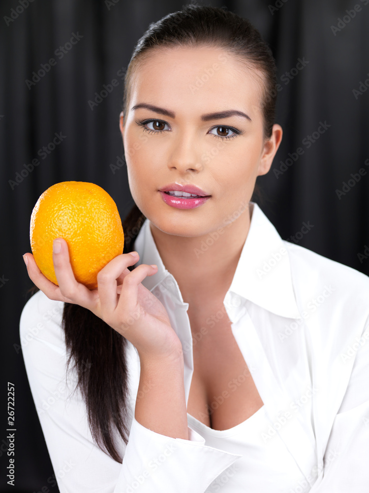 Portrait of beautiful woman, she holding orange fruit Portrait of beautiful woman, she holding orange fruit
