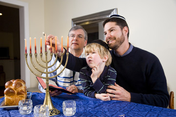 Jewish family lighting Chanukah menorah