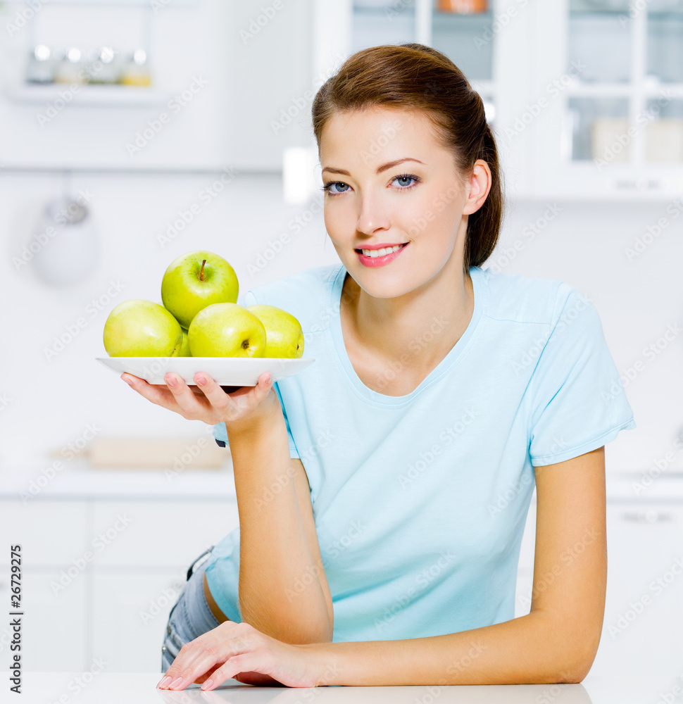 happy woman with apples on a plate happy woman with apples on a plate