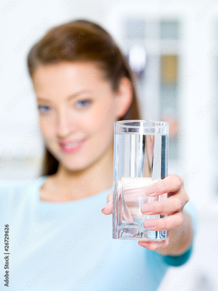 woman shows a water glass woman shows a water glass