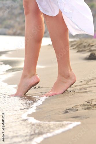 female legs on sunrise beach