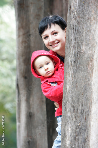 mother and child looking out from a tree
