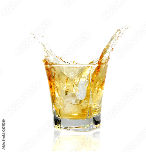 GLass of whiskey splashing out