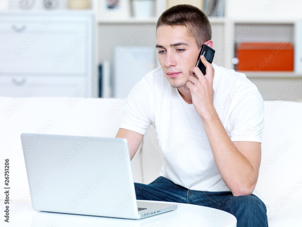 man speaks on the phone and laptop man speaks on the phone and laptop