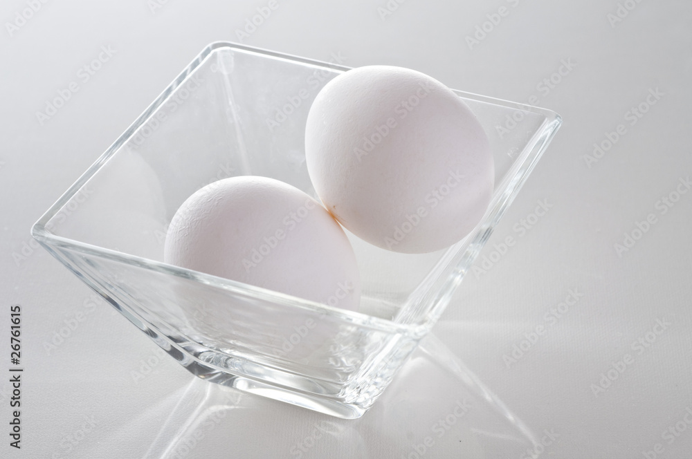 Two raw fresh white eggs in bowl Two raw fresh white eggs in bowl
