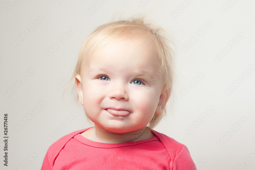 Portrait of cute young baby sit on chair and  grimacing