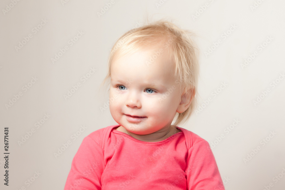 Portrait of cute young baby sit on chair and  grimacing