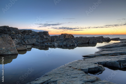 Rocks and water along the Newfoundland coastline at sunrise.