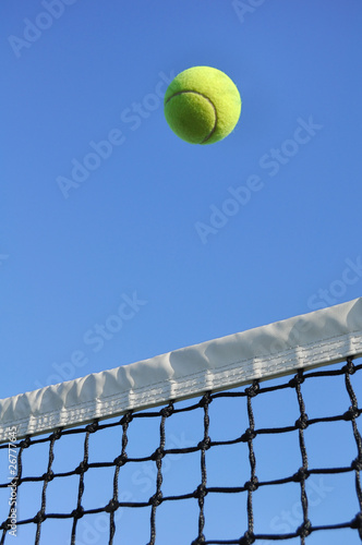 Yellow Tennis Ball Flying Over the Net