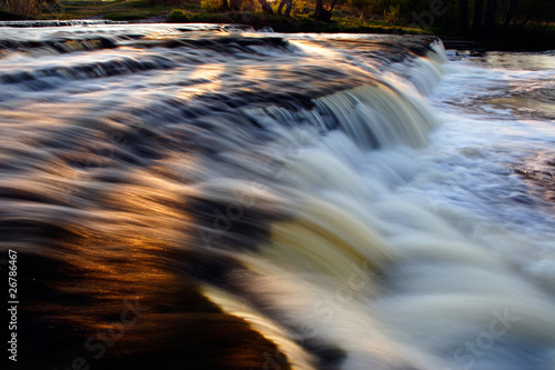 Sunset reflection on waterfall photo