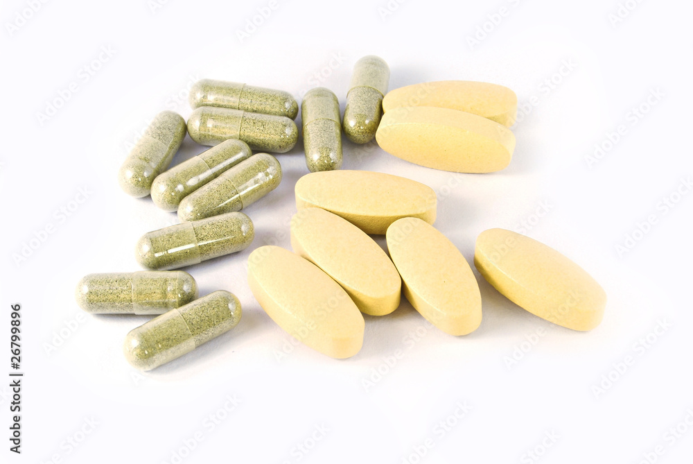 herbal medicine capsules and vitamin c tablets isolated on white herbal medicine capsules and vitamin c tablets isolated on white