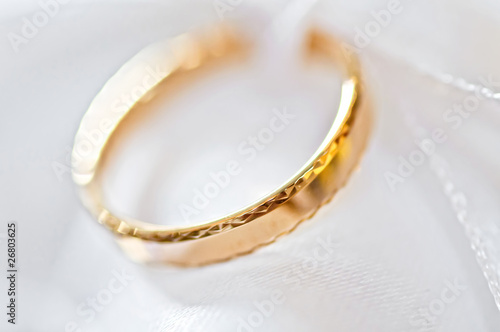 Wedding ring on a satiny fabric (macro)