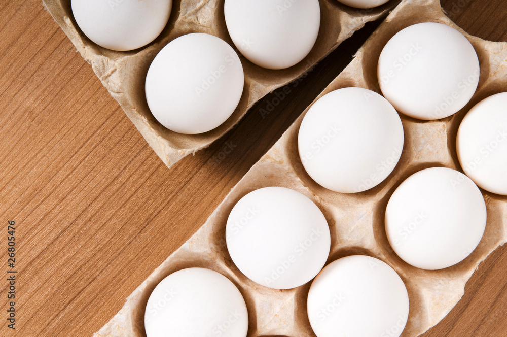 Many white eggs on the wooden table Many white eggs on the wooden table