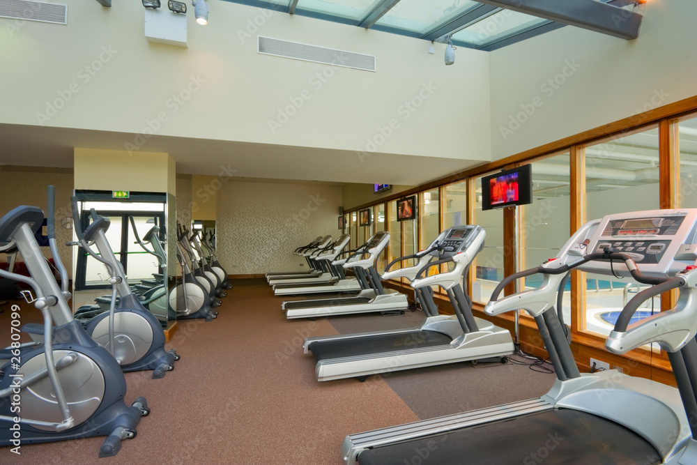 Fototapeta premium row of jogging simulators in gym